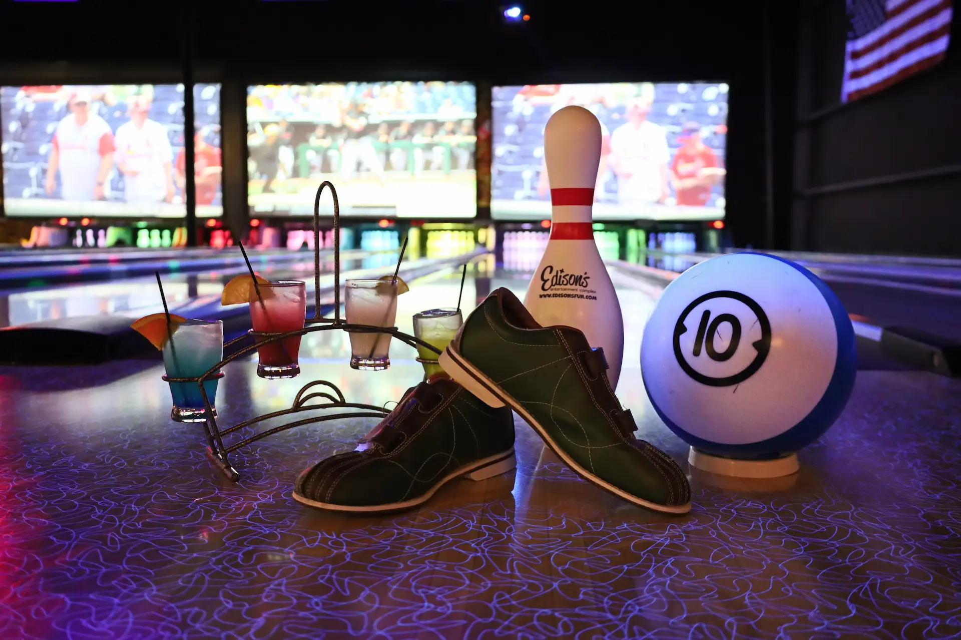 bowling alley with bowling shoes and bowling ball in the foreground