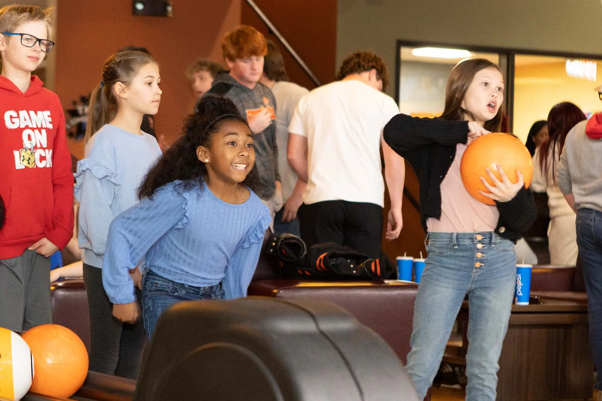 girls preparing to throw bowling balls