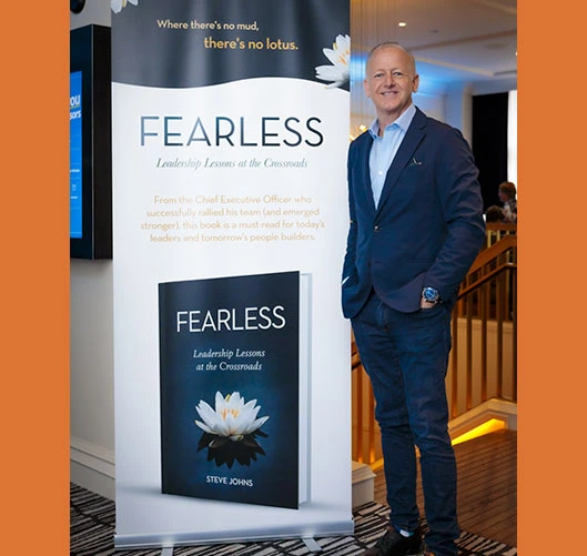 man standing next to a sign